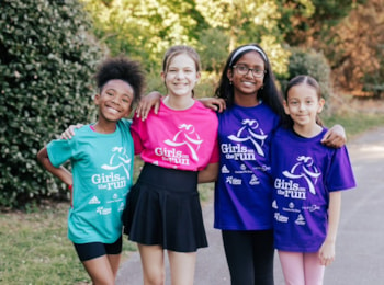 Four Girls on the Run participants smiling with arms around each other